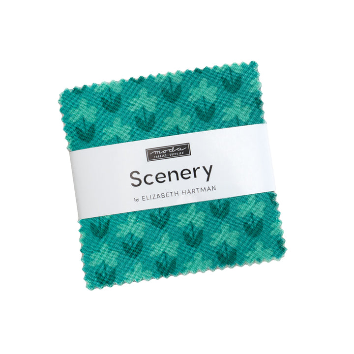 Square fabric swatch featuring a teal floral pattern with various shades of green, wrapped with a band labeled Elizabeth Hartman's Scenery Fabric Collection for modern needlework and quilting projects.