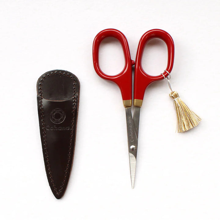 Japanese Artisan Lacquered Handle Embroidery Scissors with bright red lacquered handles, gold detailing, fine sharp blades, and a small gold tassel, shown with a stitched dark leather sheath.