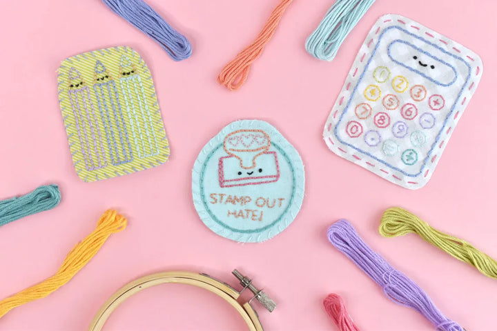 Embroidery patches with cartoon designs on a pink background