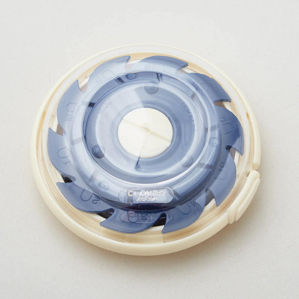 Dome Threaded Needle Case in cream and translucent gray, compact and designed for organized storage of threaded needles for embroidery and sewing projects.