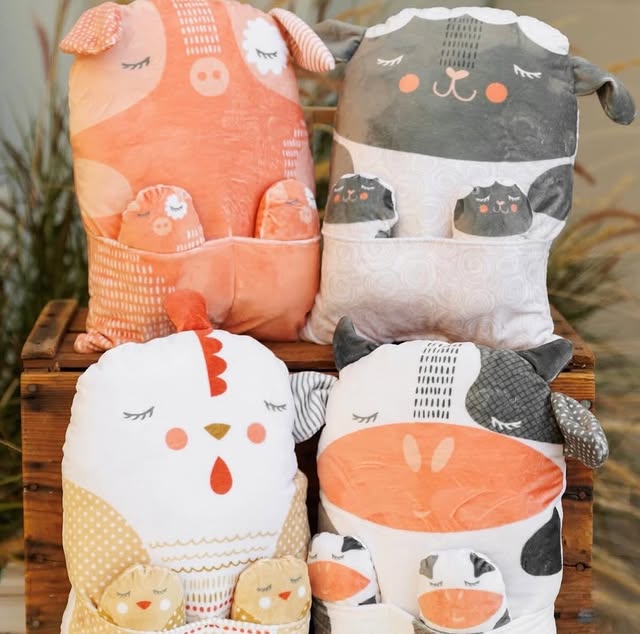 Farmstead Cuddle Animal Pillow Panel featuring soft plush pillows designed as a pig, sheep, chicken, and cow with matching baby animal details, ideal for cozy home decor.