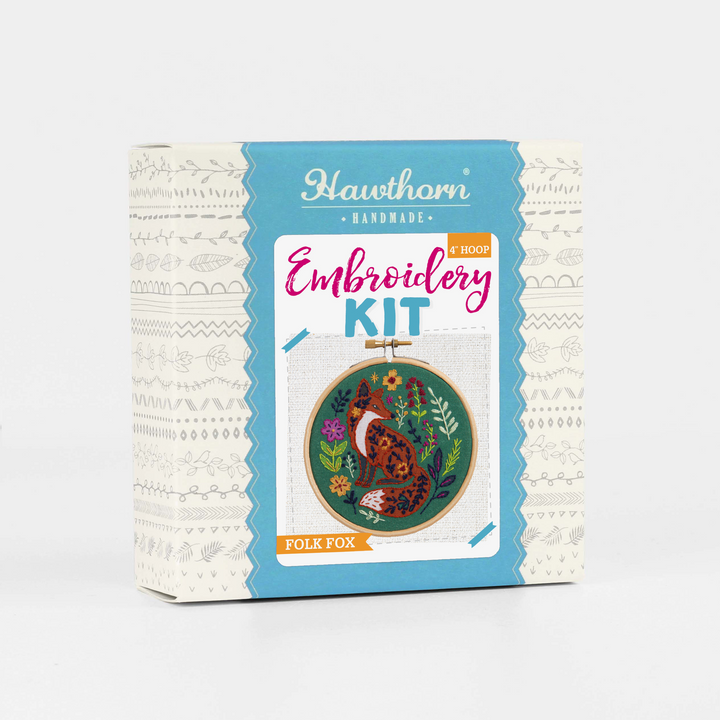 Embroidery kit packaging with fox design on a white background