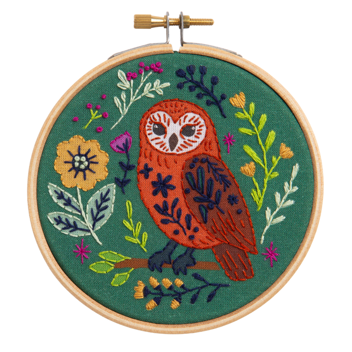 Embroidery hoop with an owl design on a green background