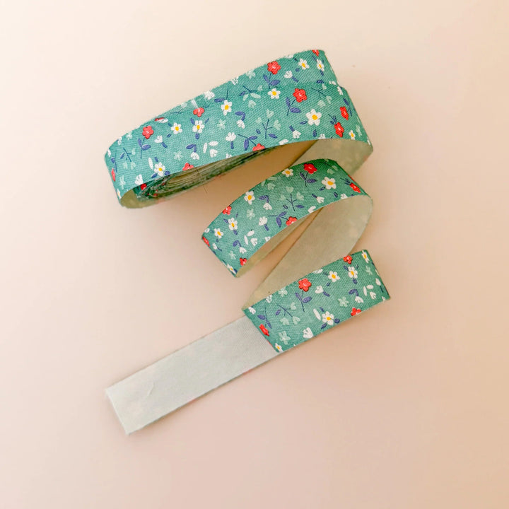 Floral-patterned ribbon on a beige background