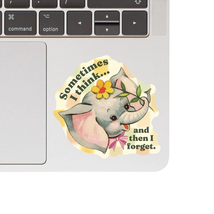 Elephant Think & Forget Vinyl Sticker featuring a cute vintage-style elephant holding a flower with the phrase "Sometimes I think... and then I forget," applied on a silver laptop surface.