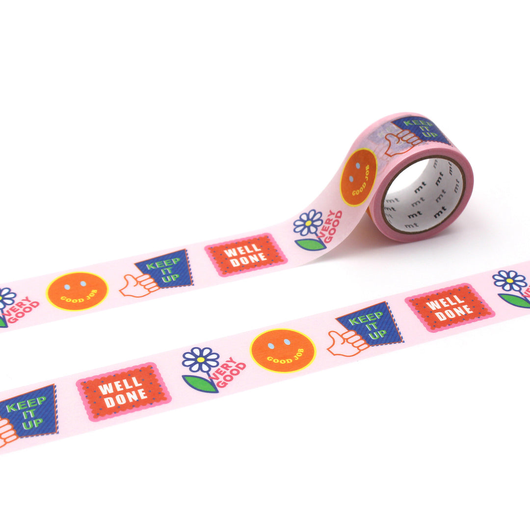 Roll of Japanese mt Washi Tape - Good Job featuring colorful positive message designs including thumbs up, flowers, smiley faces, and motivational words on a pastel pink background.