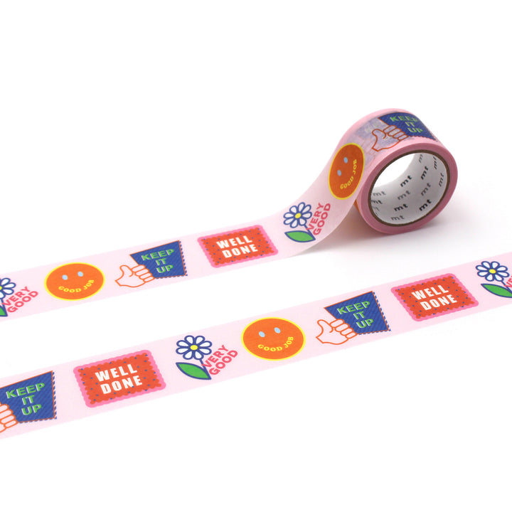 Roll of Japanese mt Washi Tape - Good Job featuring colorful positive message designs including thumbs up, flowers, smiley faces, and motivational words on a pastel pink background.