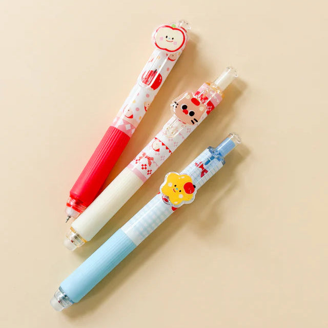 Three colorful pens with cartoon character designs on a beige background