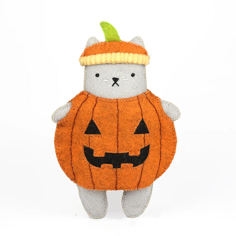 Stuffed toy cat in a pumpkin costume on a white background
