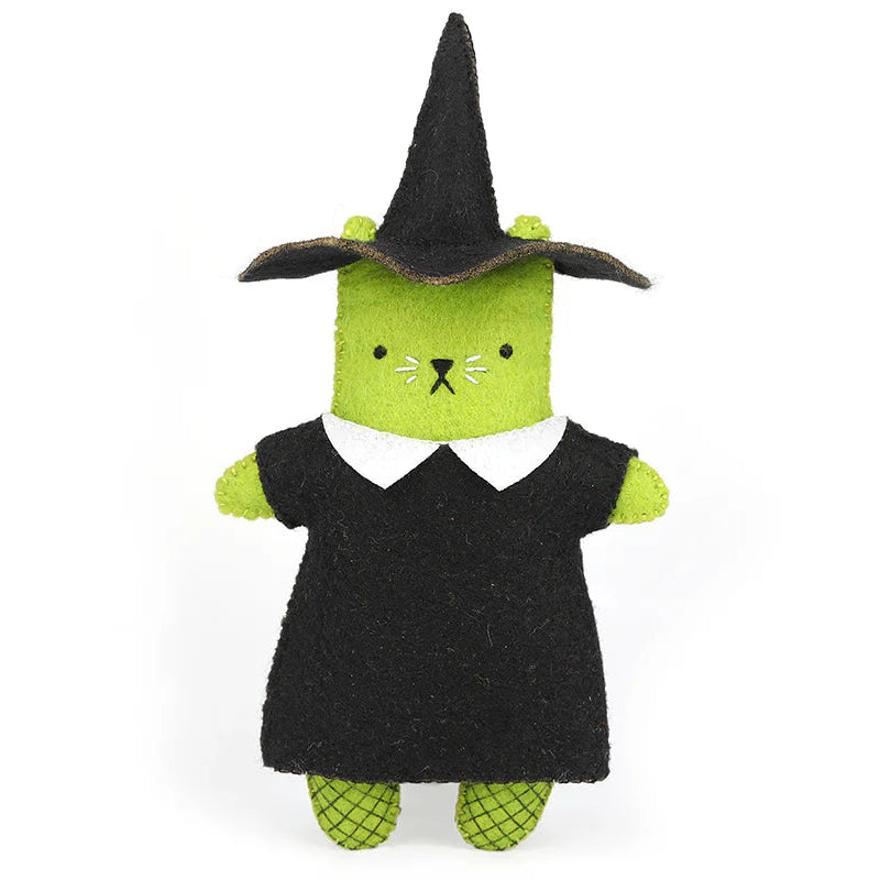 Toy figure of a cat in a witch costume on a white background