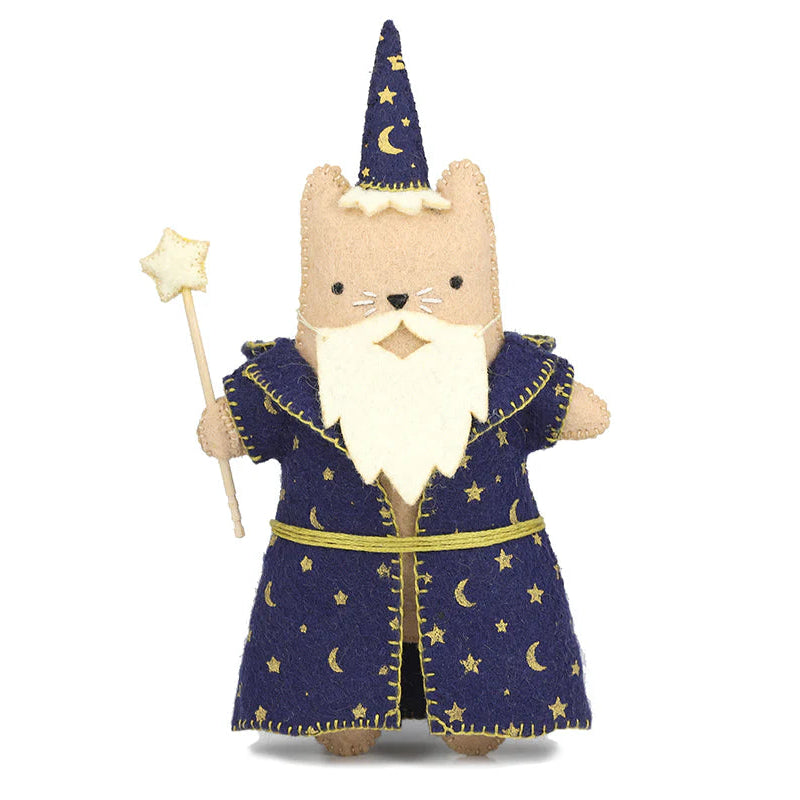Stuffed toy cat dressed as a wizard with a blue robe, hat, and holding a wand on a white background