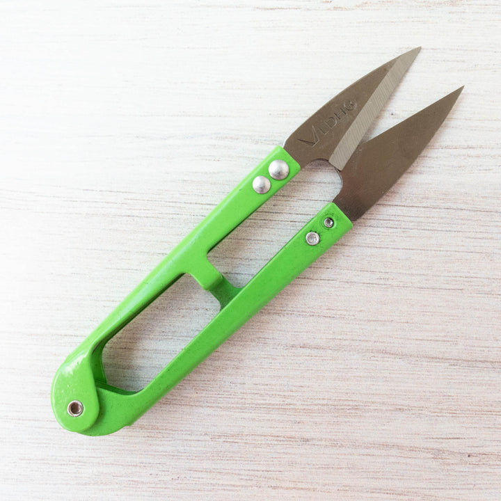 LDH Thread Snips with sharp stainless steel blades and bright green ergonomic handle designed for precision cutting in embroidery, cross stitch, and other needlework crafts.