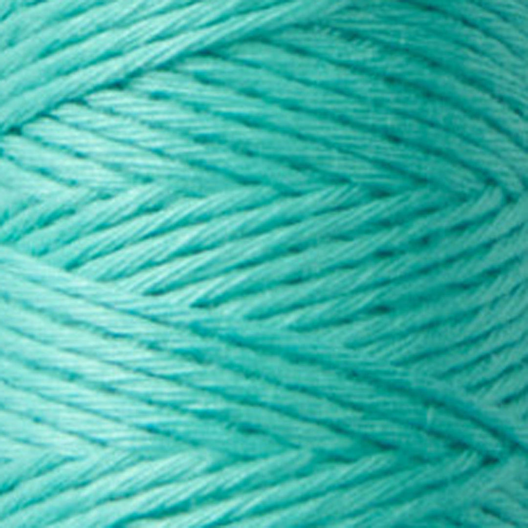 Close-up of finely twisted teal embroidery thread spool labeled Cosmo Hidamari Sashiko Thread - Teal Breeze (#25), ideal for sashiko and other Japanese craft needlework projects.