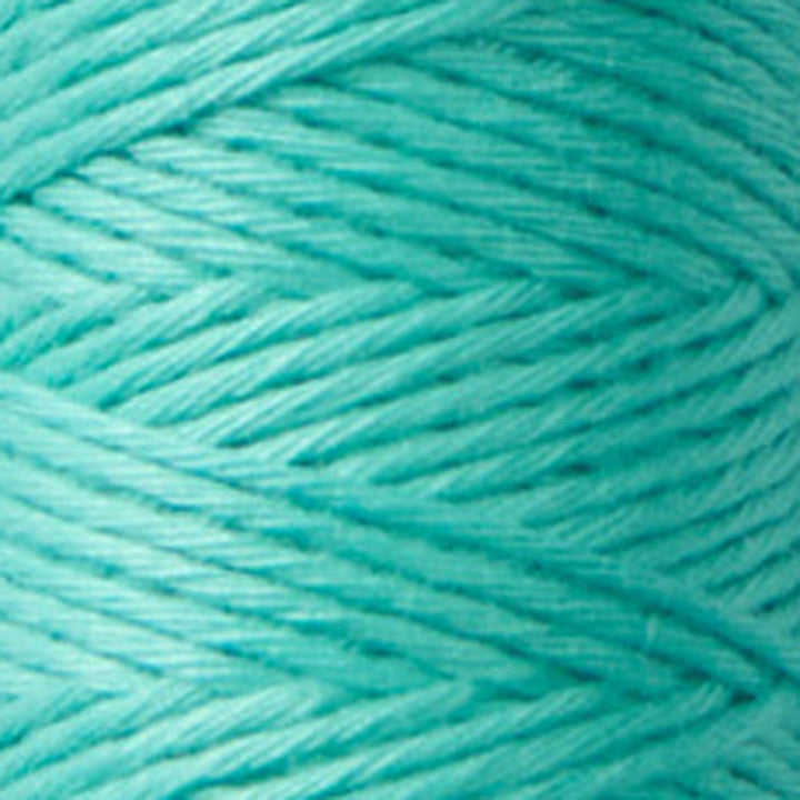 Close-up of finely twisted teal embroidery thread spool labeled Cosmo Hidamari Sashiko Thread - Teal Breeze (#25), ideal for sashiko and other Japanese craft needlework projects.