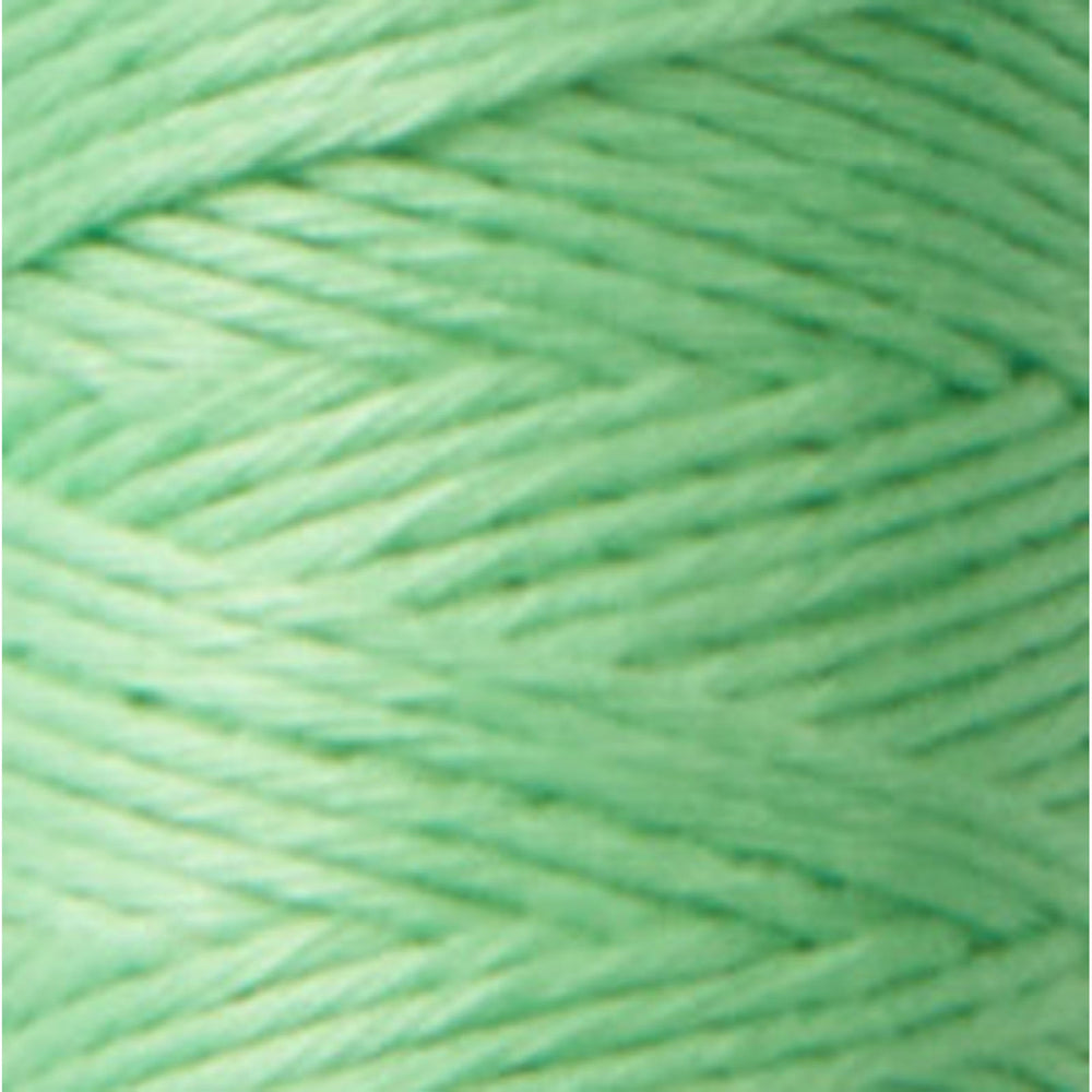 Close-up of soft pistachio green thread in a tightly wound skein, showcasing the smooth texture of Cosmo Hidamari Sashiko Thread - Pistachio (#27) for Japanese craft supplies and embroidery.