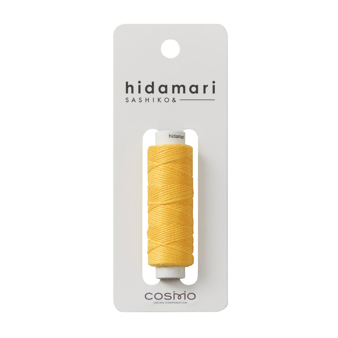 Cosmo Hidamari Sashiko Thread - Goldenrod (#28) in bright yellow shade, displayed on a white card, ideal for sashiko and modern needlework using Japanese craft supplies.