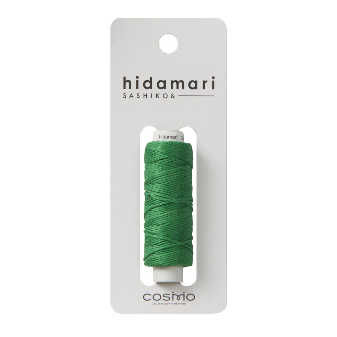 Cosmo Hidamari Sashiko Thread - Green (#31) spool displayed on white packaging, premium Japanese craft embroidery thread ideal for sashiko and modern needlework projects.