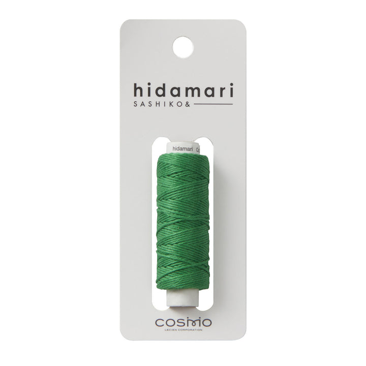 Cosmo Hidamari Sashiko Thread - Green (#31) spool displayed on white packaging, premium Japanese craft embroidery thread ideal for sashiko and modern needlework projects.