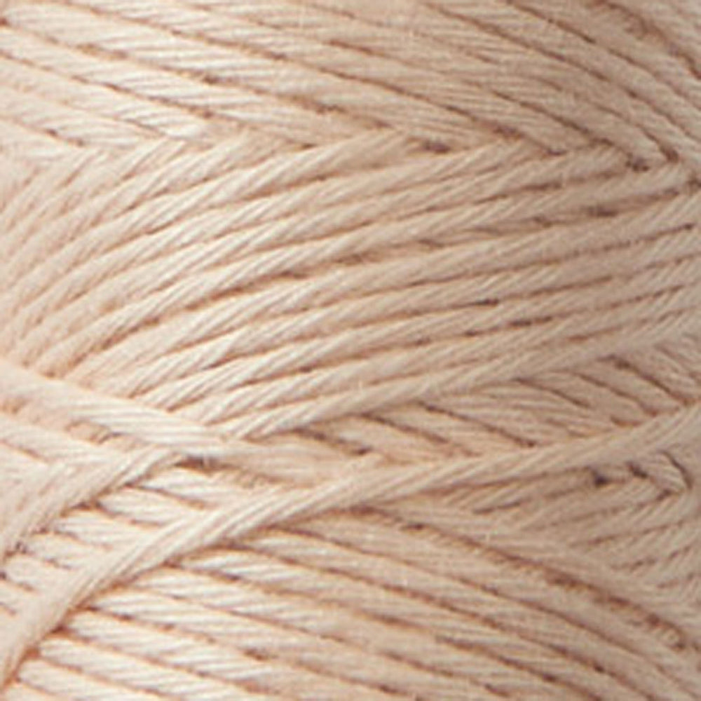 Close-up of tightly wound soft peach-colored Cosmo Hidamari Sashiko Thread - Peach Fuzz (#33) ideal for Japanese craft supplies and modern needlework projects.