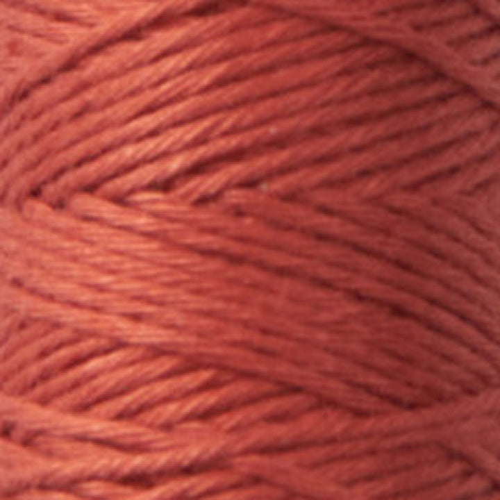Close-up of tightly wound Cosmo Hidamari Sashiko Thread - Burnt Persimmon (#34) in a rich warm orange shade, ideal for Japanese craft supplies and sashiko embroidery projects.