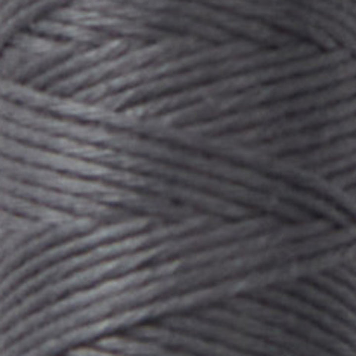 Close-up view of dark gray thread spool featuring Cosmo Hidamari Sashiko Thread - Iron (#35), ideal for Sashiko embroidery and Japanese craft supplies.
