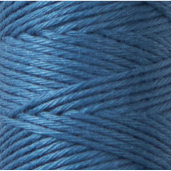 Close-up of vibrant blue embroidery thread spool featuring Cosmo Hidamari Sashiko Thread - Cobalt Blue (#37), ideal for Japanese craft supplies and sashiko needlework projects.