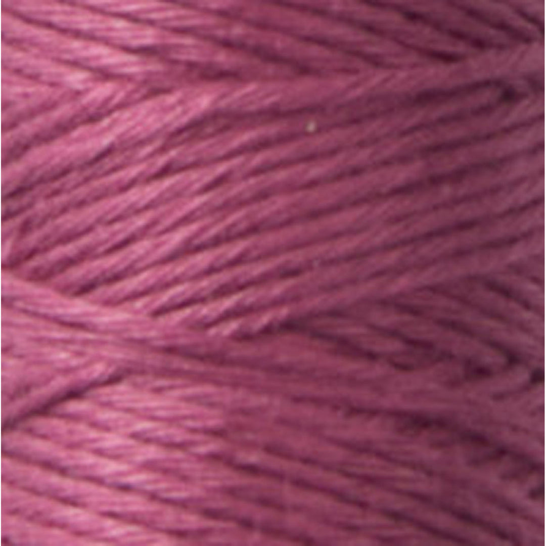 Close-up of smooth, tightly wound embroidery thread in a muted mauve color, featuring Cosmo Hidamari Sashiko Thread - Mulberry Blush (#38) for delicate sashiko and needlework projects.