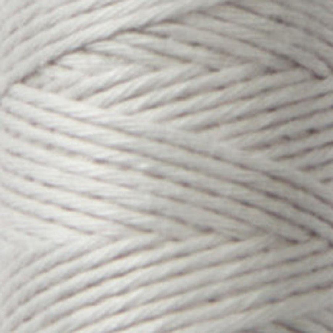 Close-up of soft, light gray Cosmo Hidamari Sashiko Thread - Misty Coast (#39) spool showcasing fine texture ideal for Japanese craft supplies and modern needlework projects.