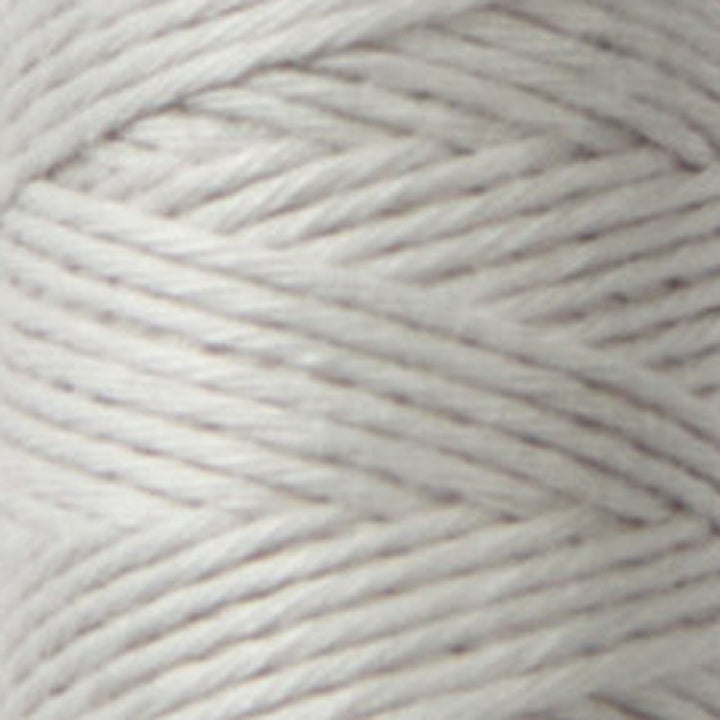 Close-up of soft, light gray Cosmo Hidamari Sashiko Thread - Misty Coast (#39) spool showcasing fine texture ideal for Japanese craft supplies and modern needlework projects.