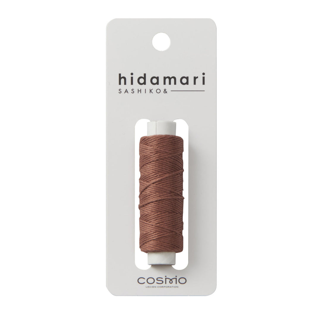 Cosmo Hidamari Sashiko Thread - Brown (#40) displayed on white card packaging, showing smooth, tightly wrapped brown thread for sashiko and embroidery crafting.