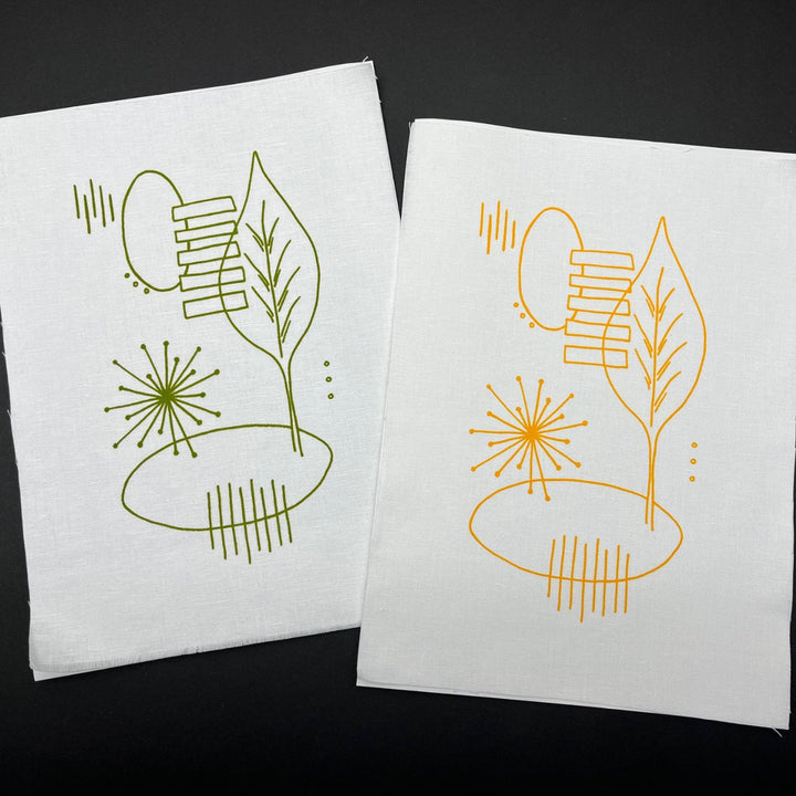 Freestyle Embroidery Kit - Leaf Print showing two fabric pieces with modern abstract leaf designs stitched in green and yellow embroidery thread, ideal for hand embroidery kits and modern needlework.