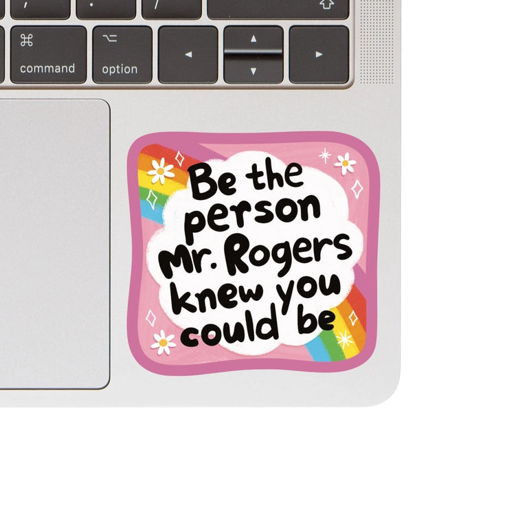 Mr. Rogers Vinyl Sticker with an inspirational quote in playful black text on a white cloud background, framed by a pink border and rainbow accents, ideal for laptops.