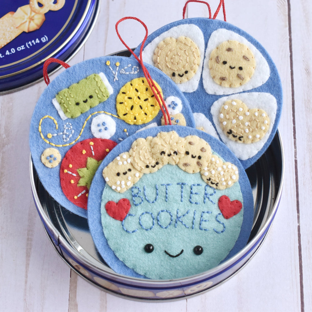 Decorative cookie tin with cute face design on a wooden surface