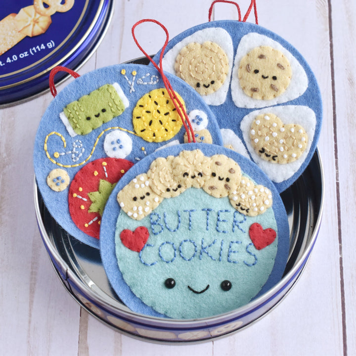 Decorative cookie tin with cute face design on a wooden surface