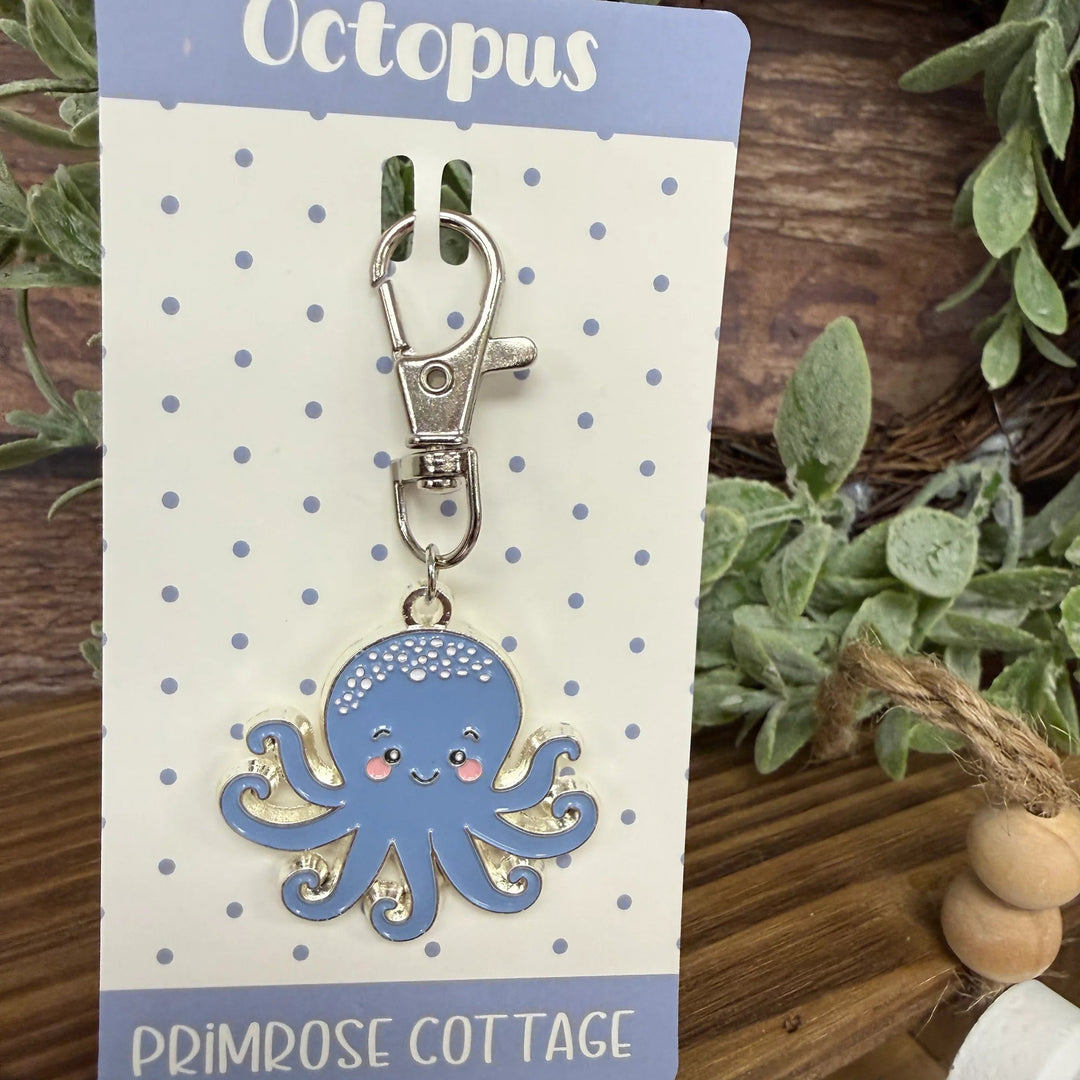 Blue octopus keychain on a Primrose Cottage branded card with plants in the background