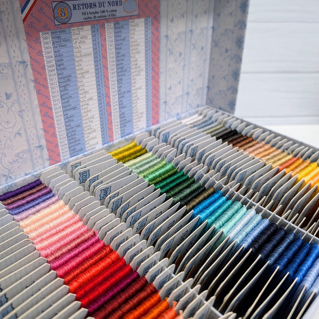 Retors du Nord French Embroidery Floss - Complete Set displaying a wide range of vibrant embroidery thread colors neatly organized in a decorative box for needlework and cross stitch projects.