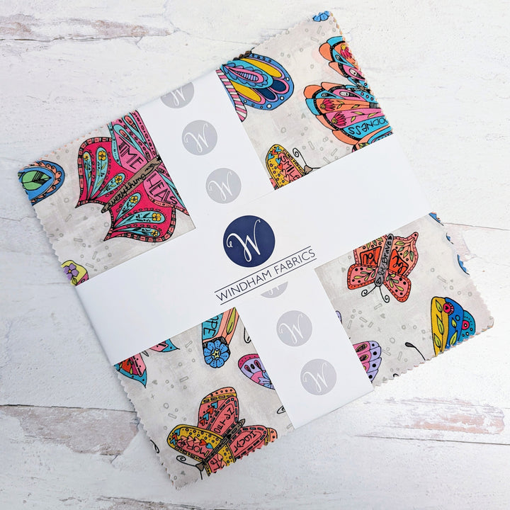 10" Squares Cotton Fabric Layer Cake - Sway" featuring colorful butterfly prints on light fabric, ideal for quilting, sewing, and modern needlework projects.