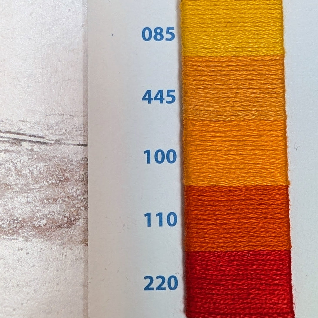 Hilo Vela El Globo Embroidery Thread (8m Skeins) - Orange showing a gradient of warm tones from yellow to deep red, ideal for modern needlework and Japanese craft supplies.