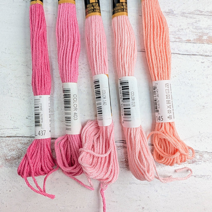 Hilo Vela El Globo Embroidery Thread (8m Skeins) - Light Pink displayed in various shades from deep pink to soft peach, ideal for modern needlework and Japanese craft supplies.