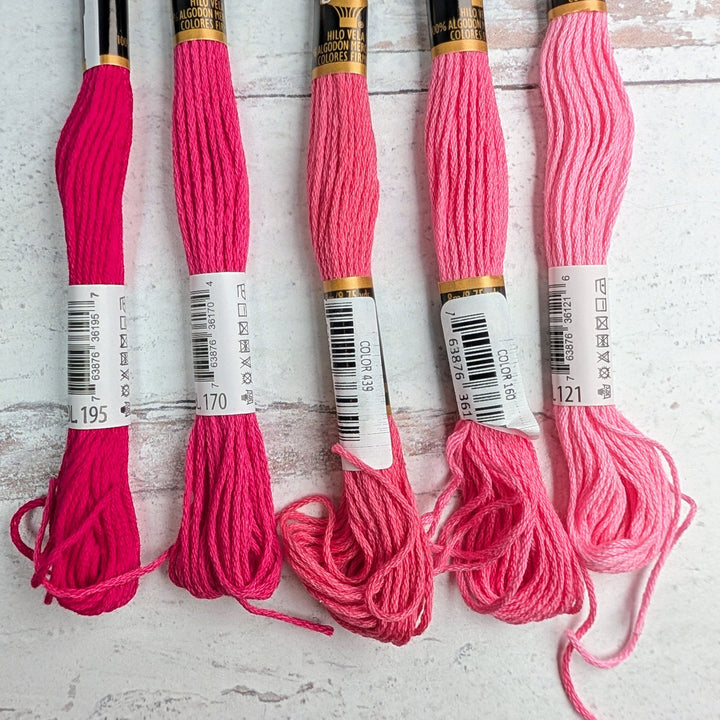 Hilo Vela El Globo Embroidery Thread (8m Skeins) - Pink displayed in various shades from deep to light pink, ideal for hand embroidery, cross stitch, and modern needlework projects.