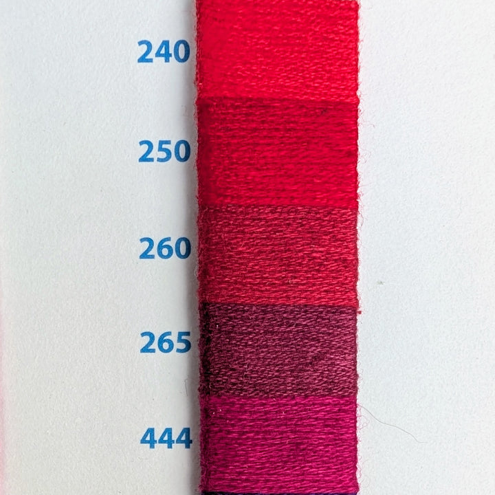 Hilo Vela El Globo Embroidery Thread (8m Skeins) - Reds showing five shades of red and pink embroidery floss samples numbered 240, 250, 260, 265, and 444 on white background for needlework projects.