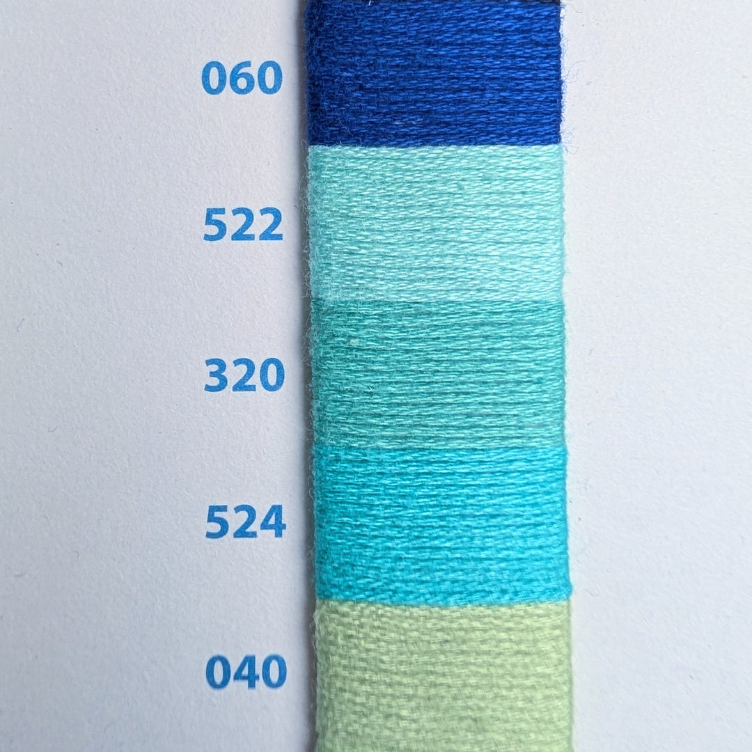 Color swatch with blue, green, and beige embroidery floss samples on a white background