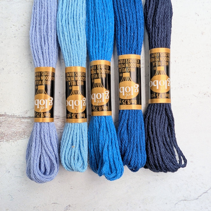 Hilo Vela El Globo Embroidery Thread (8m Skeins) -Blue in various shades ranging from light lavender to deep navy, perfect for needlework, cross stitch, and Japanese craft supplies projects.