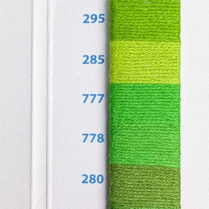 Hilo Vela El Globo Embroidery Thread (8m Skeins) - Bright Green shown in various shades on a thread color card, ideal for Japanese craft supplies and embroidery projects.
