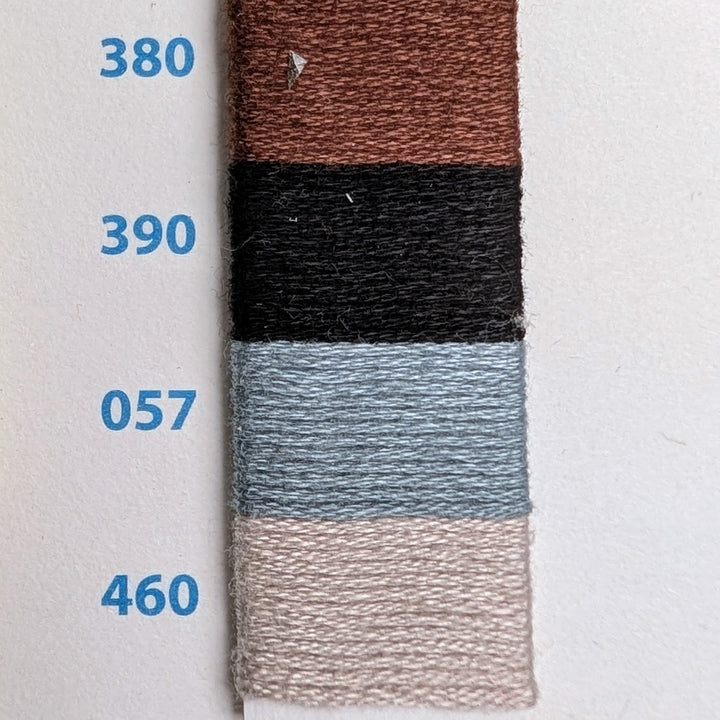 Hilo Vela El Globo Embroidery Thread (8m Skeins) - Neutrals showing four shades of thread in brown, black, light blue, and beige on a color chart with numeric labels for embroidery and modern needlework projects.