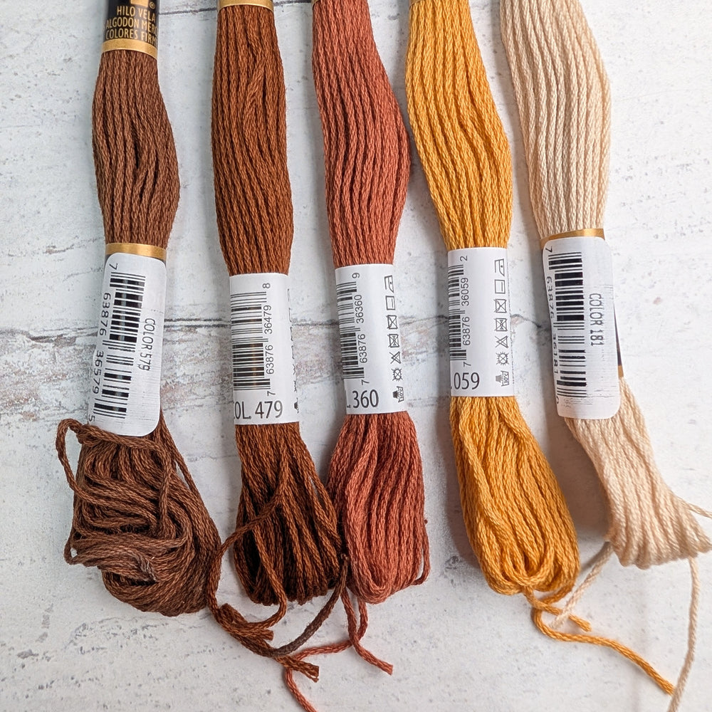 Hilo Vela El Globo Embroidery Thread (8m Skeins) - Brown in various shades arranged side by side on a light surface, showcasing rich tones suitable for embroidery, cross stitch, and modern needlework projects.