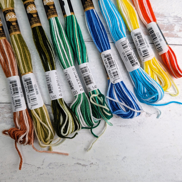 Hilo Vela El Globo Embroidery Thread (8m Skeins) - Variegated One displayed in various earthy to bright colors including browns, greens, blues, yellows, and reds, ideal for Japanese craft supplies and modern needlework projects.