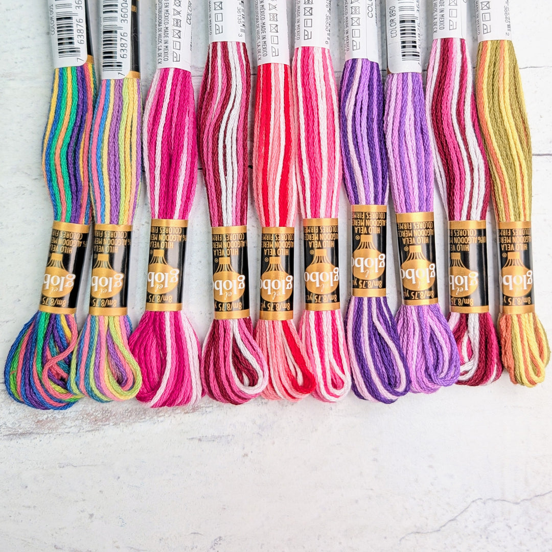 Hilo Vela El Globo Embroidery Thread (8m Skeins) - Variegated Two in colorful shades including blue, green, pink, red, purple, and yellow, ideal for hand embroidery and needlework crafts.
