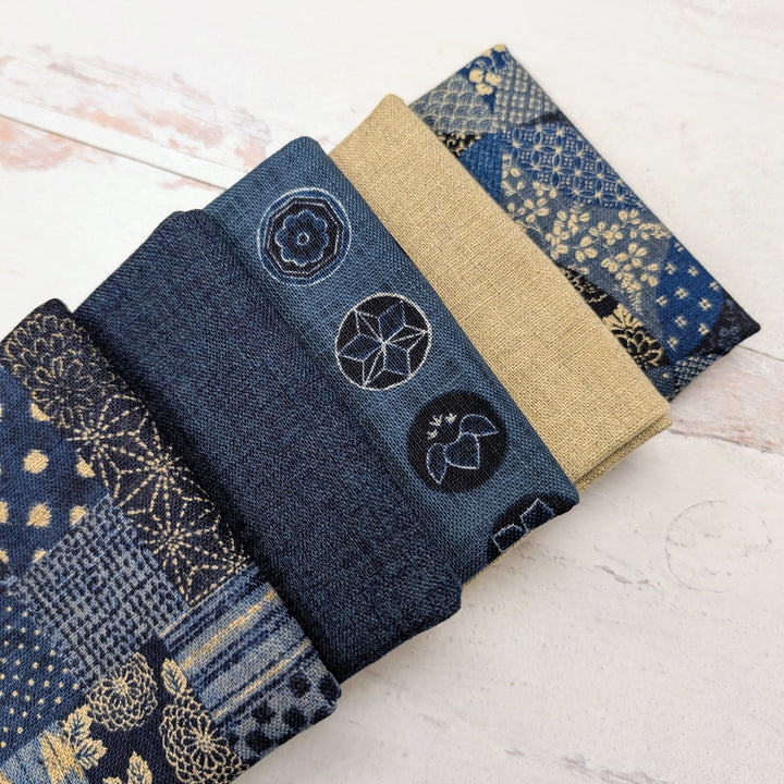 Homespun Rustic Weave Fat Quarter Bundle featuring a selection of blue and beige fabrics with traditional patterns and textures, perfect for modern needlework and sewing projects.