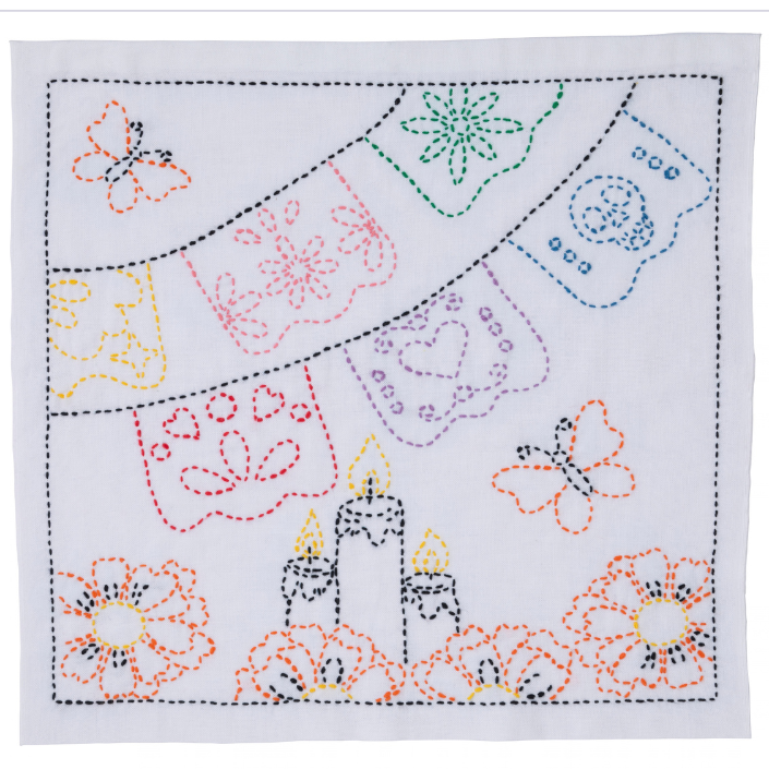 A sashiko sampler from the Sashiko World collection featuring design inspired by Day of the Dead with Papel Picado banners, Cempasuchil, candles and monarch butterflies on a white background